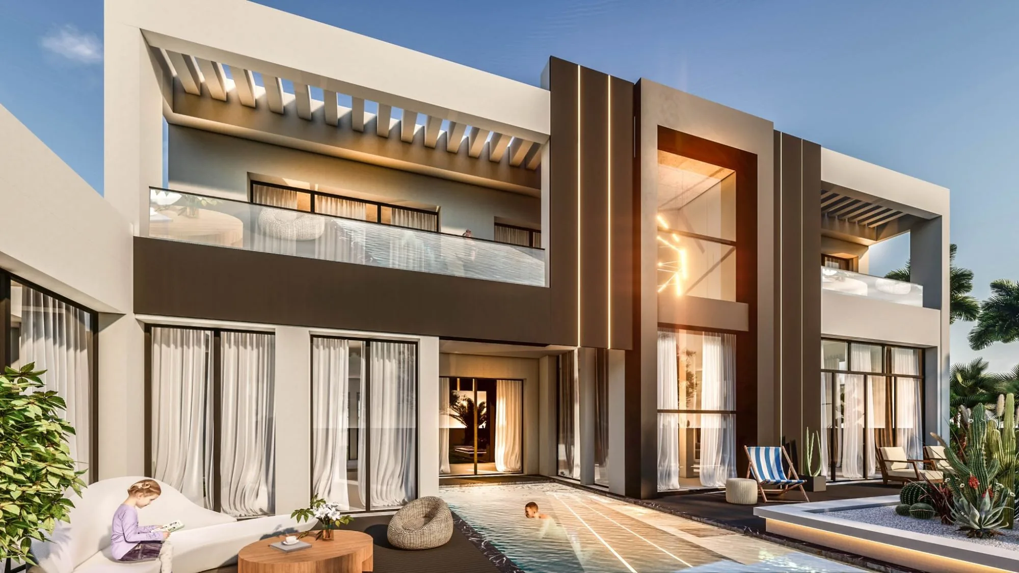 Villa lit at dusk, pool and upper-floor terrace