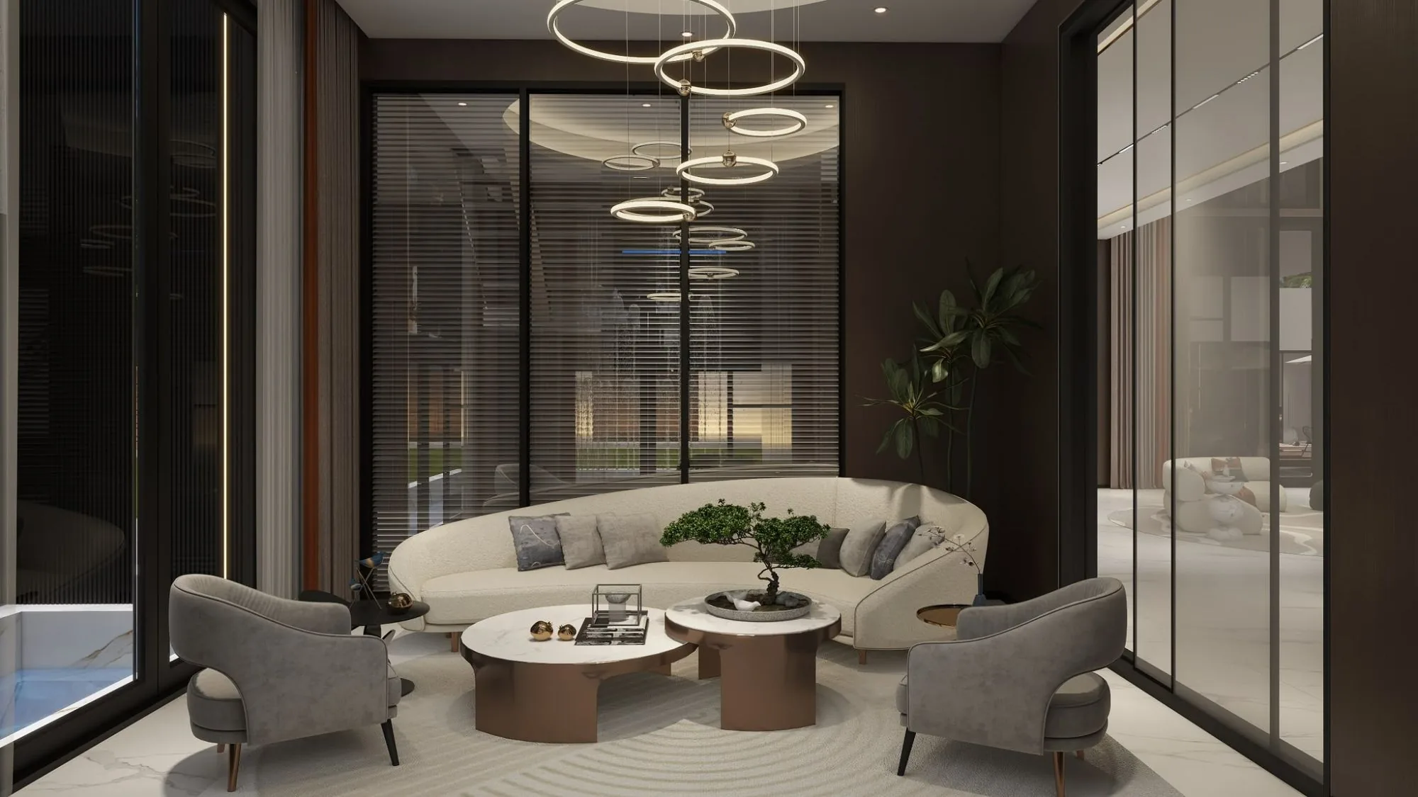 Living room with a curved sofa under circular pendant lights, bonsai on the coffee table